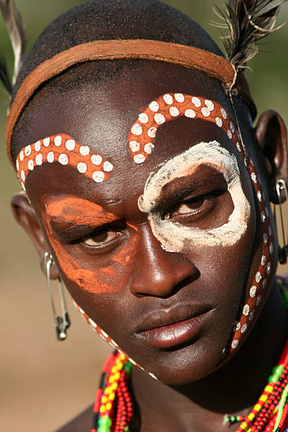 Portrait of Hamer Man "Turmi, South-West Ethiopia, Ethiopia - March 14, 2010: Close up portrait of a young man preparing for traditional ceremony where he will become a man, member of the Hamer tribe. The Hamer (also spelled Hamar) are a tribal people in southwestern Ethiopia. They live in Hamer Bena woreda (or district), a fertile part of the Omo River valley, in the Debub Omo Zone of the Southern Nations, Nationalities, and Peoples Region (SNNPR). They are largely pastoralists, so their culture places a high value on cattle." hamer tribe photos stock pictures, royalty-free photos & images