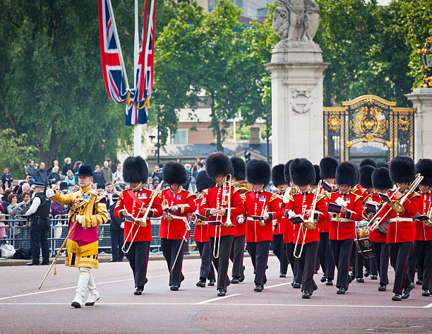LONDON, UNITED KINGDOM -  4 AUGUSTUS  2023: officers and soldiers of the coldstream guards march in front of buckingham palace during the changing of the guard ceremony