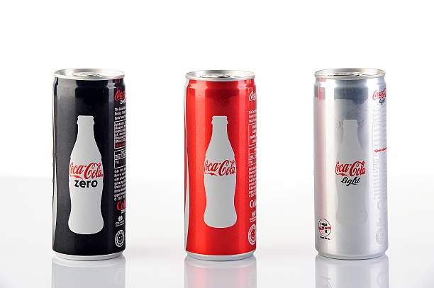 Group of 200ml Coca-Cola Cans "Astanbul, Turkey - July 31, 2013: Coca-Cola 200ml products on white background with reflections. Include Cola-Cola Zero and Coca-Cola Light" coke zero photos stock pictures, royalty-free photos & images
