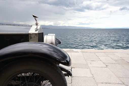 Opatija, Сroatia - June 25, 2013: The front end of the beautiful old Rolls Royce with the hood ornament, Spirit of Ecstasy, parked on waterfront of Opatija. The ornament is in the form of a woman leaning forwards with her arms outstretched behind and above her. Billowing cloth runs from her arms to her back, resembling wings.