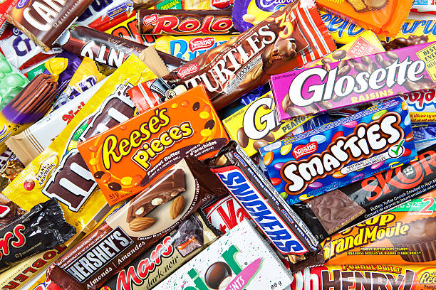 Large Assortment of Chocolate Candy Products "Toronto, Canada - May 8, 2012: This is a studio shot of a variety of chocolate products made by various companies including Nestle, Hershey's, Mars Inc., and Cadbury isolated on a white background." chocolate bar photos stock pictures, royalty-free photos & images