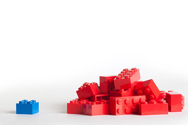 Large group of red lego blocks and one blue block "Ski, Norway - March 26, 2012: Lego blocks with copy space. The Lego toys were originally designed in the 1940s in Denmark and have achieved an international appeal." lego stock pictures, royalty-free photos & images