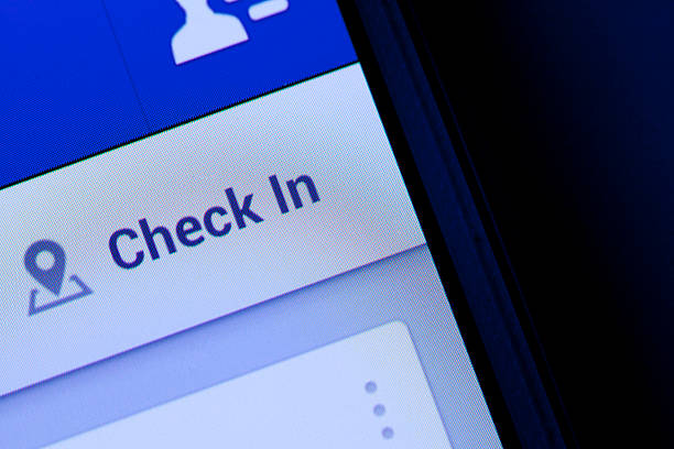 Check in button for facebook "New York City, USA - September 12, 2013: Close-up view of the ""check in"" button in facebook on a smart phone. Facebook is a social networking service, owned and operated by Facebook, Inc." airport check in counter photos stock pictures, royalty-free photos & images