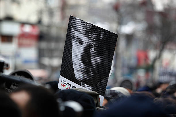 Hrant Dink commemoration "Istanbul,Turkey-January 19,2012:Thousands marched for the fifth anniversary of Armenian journalist Hrant Dinkaas murder in Istanbul.He was shot dead in Istanbul outside his newspaper Agos in 2007. Some carried portraits of the journalist." hrant dink stock pictures, royalty-free photos & images