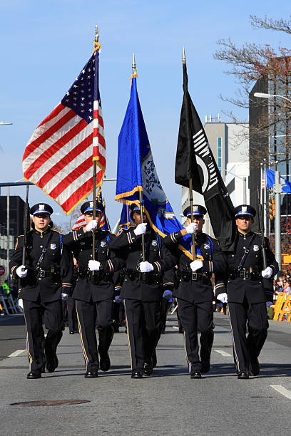honor guards "Stamford, USA - November 20, 2011: Police honor guards participating at the parade. Since the first Thanksgiving Day Parade 1993 with only a few hundred spectators the parade has become an annual event on the saturday bere Thanksgiving. Today's UBS Parade Spectacular is now attracting well over 100,000 of the city citizens and those from the surrounding towns. The people are enjoying the 21 colorfull balloons, marching bands and the many more entertainers participating in the parade." military parade stock pictures, royalty-free photos & images