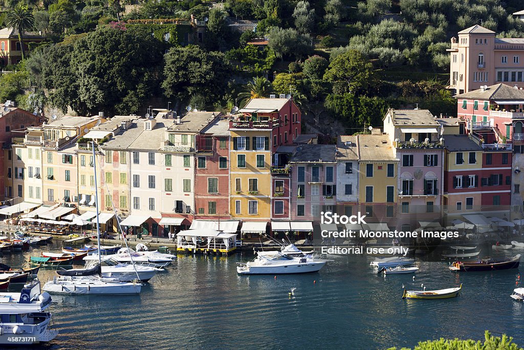 Portofino on the Riviera di Levante, Italy "Portofino, Italy - September 6, 2013: Small boats and yachts moored at the harbour of Portofino on the Italian Riviera. Many tourists are visible walking along the promenade." Aerial View Stock Photo