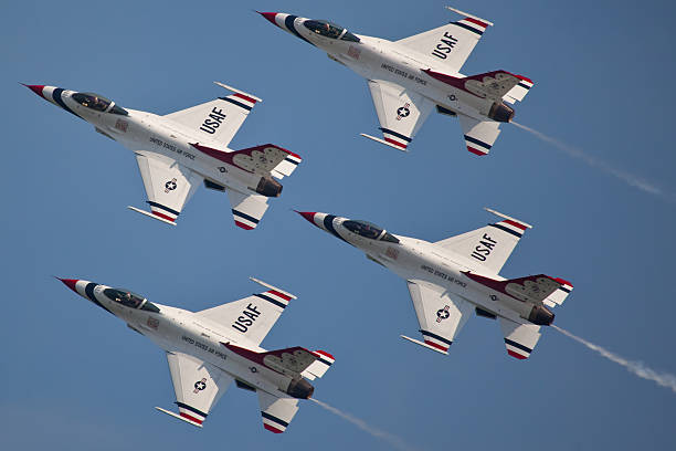 USAF Thunderbirds "Ocean City, USA - June 4, 2010:  United States Air Force Thunderbirds Demonstration Squadron flying in formation presentic characteristics od F-16 Fighting Falcon pinted in the famous blue red and white color which are also colors of the Flag of the United States of America" supersonic airplane editorial airplane air vehicle stock pictures, royalty-free photos & images