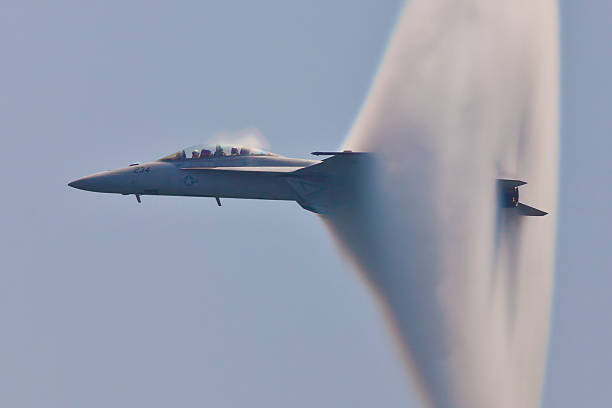 F/A-18 Super Hornet Vapor Cone "Ocean City, USA - June 12, 2011: F/A-18 Super Hornet speed pass with spectacular visible vapor cone which is effect called Prandtl - Glauert singularity when plane travels with subsonic speed in specific weather condition." fa 18 hornet stock pictures, royalty-free photos & images