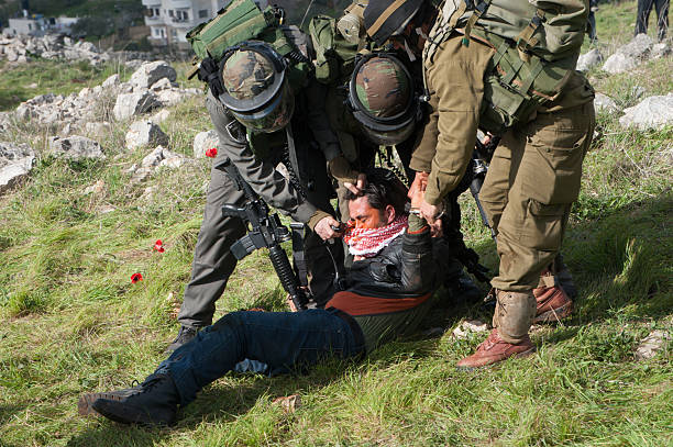 Israeli soldiers arrest Palestinian stock photo