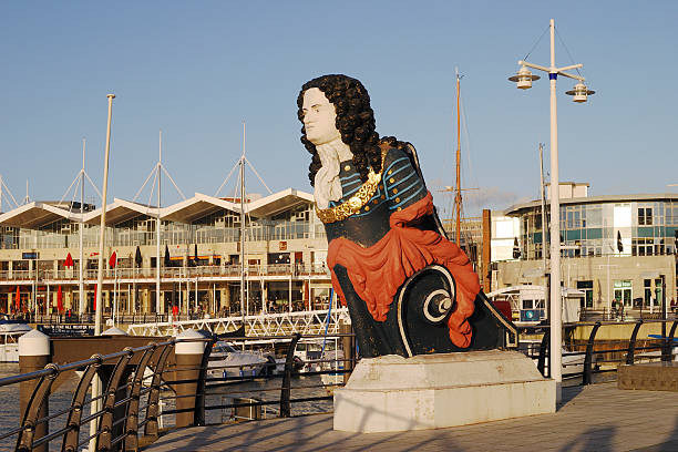 Gunwharf Quays in Portsmouth. Hampshire. England "Portsmouth, Hampshire, England - January 1, 2012 : Old ships figurehead at entrance to Gunwharf Quays shopping mall." figurehead stock pictures, royalty-free photos & images