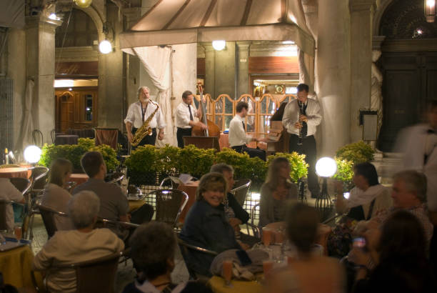 Cannobio, Italy - August 14, 2018: Historic house facades in Cannobio with restaurants along the promenade of Lake Maggiore. Cannobio is a town in Piedmont in northern Italy