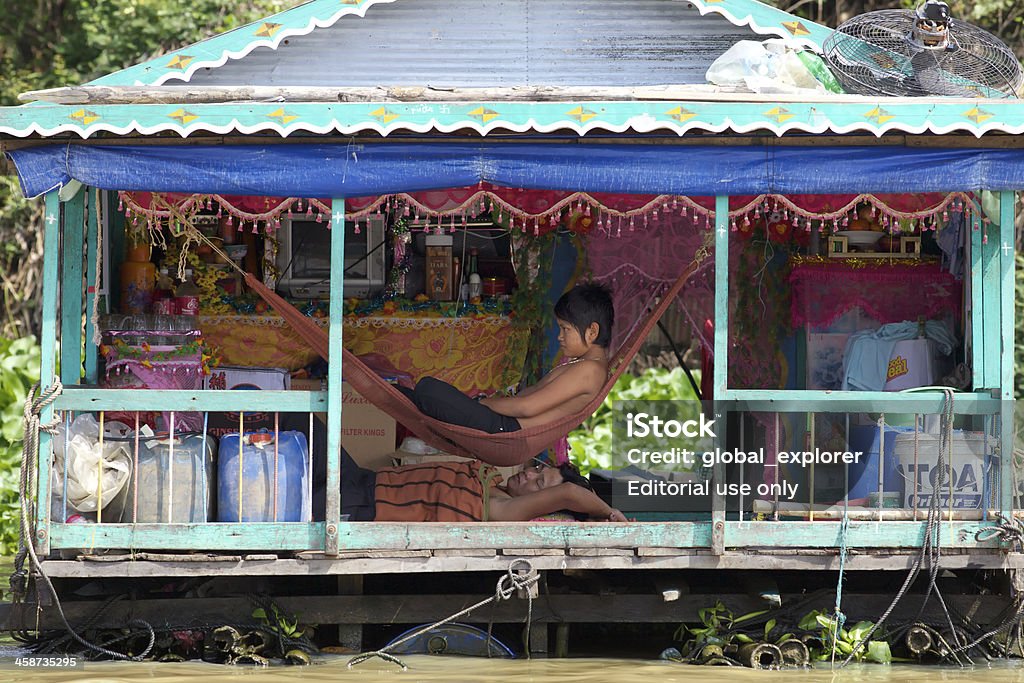 Cambodia Floating House Siem Reap, Cambodia - January 23, 2012: A typical floating house located on Tonle Sap Lake in Siem Reap, Cambodia on January 23, 2012 Domestic Life Stock Photo