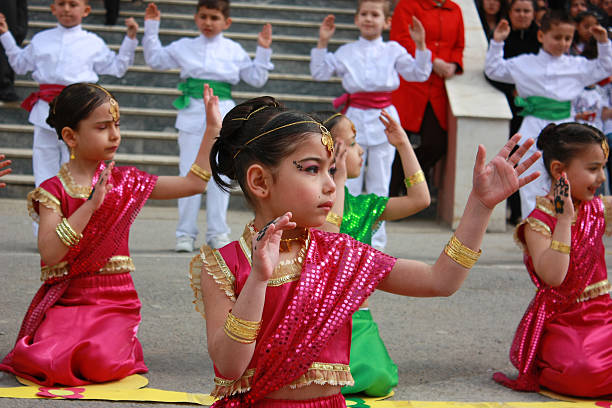 Students dancing in Indian costumes for 23 April Festival "Kocaeli, Turkey - April 23, 2011: Students dancing in Indian costumes for 23 April Children Festival" indian music stock pictures, royalty-free photos & images