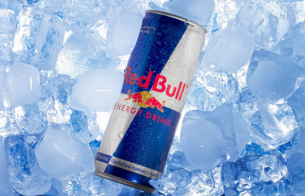 Red Bull can in Ice "Valencia, Spain - August 3, 2012: A can of Red Bull on ice. Red Bull Energy Drink was created by Austrian entrepreneur Dietrich Mateschitz in 1987. Red Bull is sold in a tall and slim blue-silver can." energy drink photos stock pictures, royalty-free photos & images