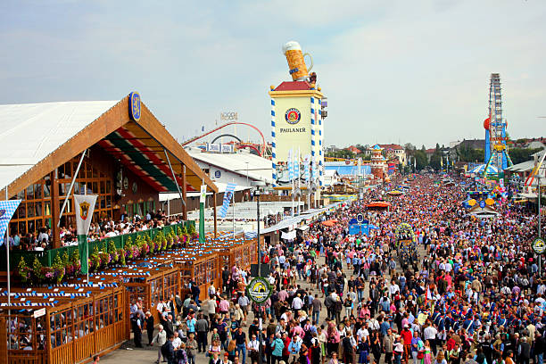 Munich Oktoberfest "Munich, Germany - September 23, 2012: You can see a mixture of people in traditional Tracht as well as an orchestra and ornate horses of the festive procession in the morning of the first festival-weekend. The image was taken from the Bavaria-Statue on the Theresienwiese." bavarian flag stock pictures, royalty-free photos & images