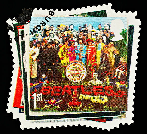 Beatles Pop Group Postage Stamp "Exeter, United Kingdom - March 07, 2010: British Postage Stamp showing the Sergeant Peppers Lonely Hearts Club Band Beatles Album Cover, circa 2007" beatles stock pictures, royalty-free photos & images