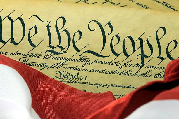 istock American Constitution and US Flag 458806361