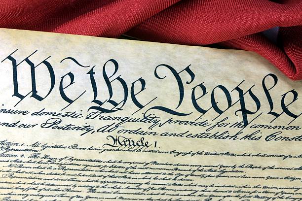 istock American Constitution and US Flag 458806373
