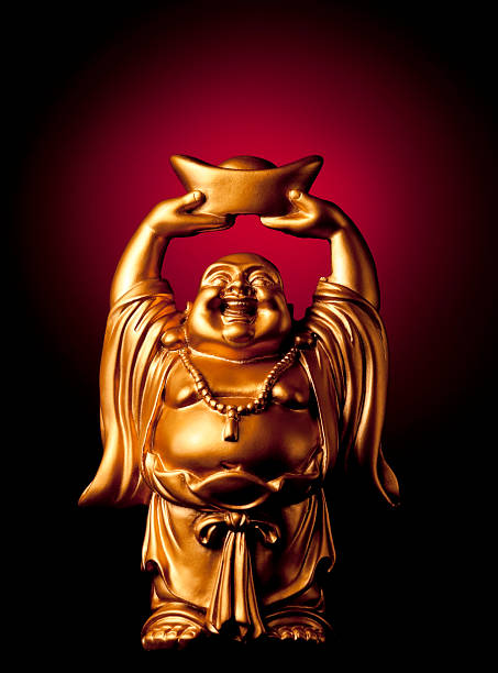 Gold Prosperity Buddha Maitreya A small, golden, carved statue of the Buddha Maitreya (also known as the Laughing Buddha).  This image said to bring fortune and prosperity to the owner. buddha photos stock pictures, royalty-free photos & images