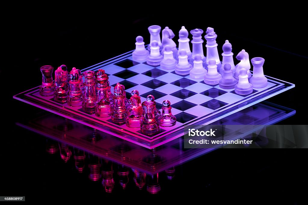 Glass Chess Set A glass chess set, lit with purple and red. Bishop - Chess Piece Stock Photo