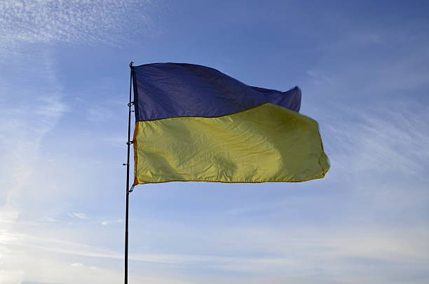 istock Ukraine flag on blue sky background 458812203