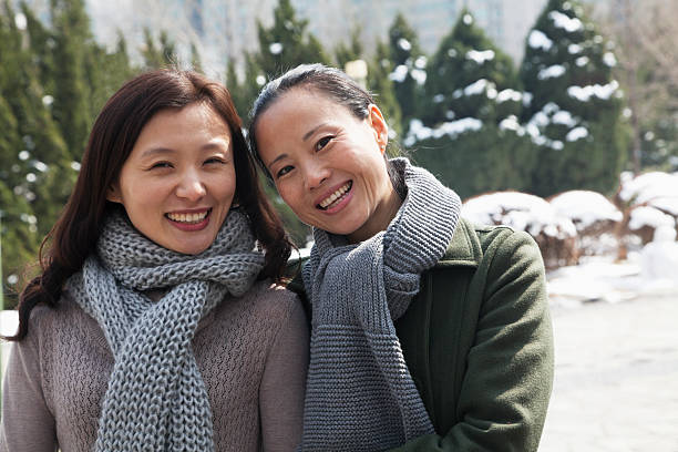 istock Two friends at park covered in snow, portrait 458829597