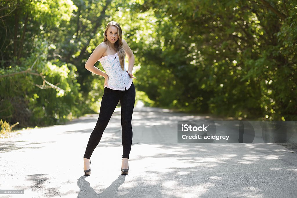 Sexy young woman Sexy young woman wearing black leggings and corset Adult Stock Photo