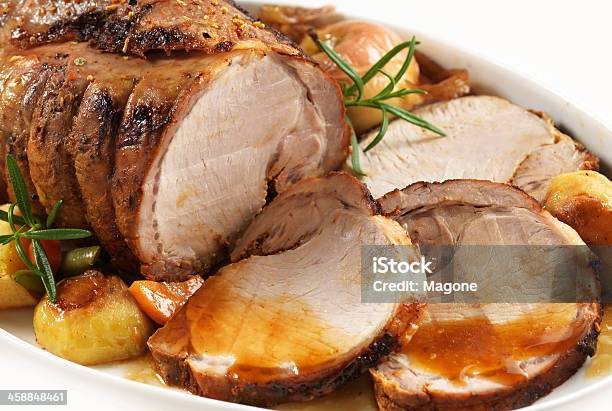 Sliced Roasted Pork With Garnish On An Oval Plate Stock Photo - Download Image Now - Pork, Loin, Roasted