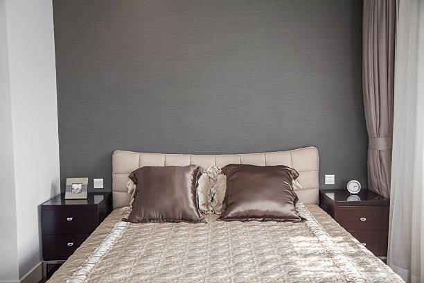 istock Bright, modern bedroom with beige bedspread. 458850815