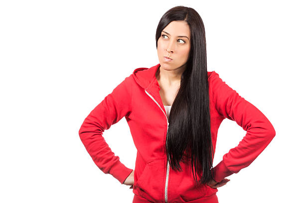 istock angry young woman standing against white 458850975