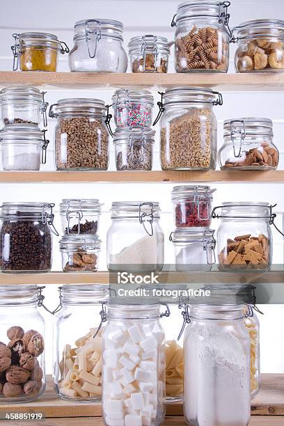 A Pantry Filled With Glass Jars Of Various Ingredients Stock Photo - Download Image Now