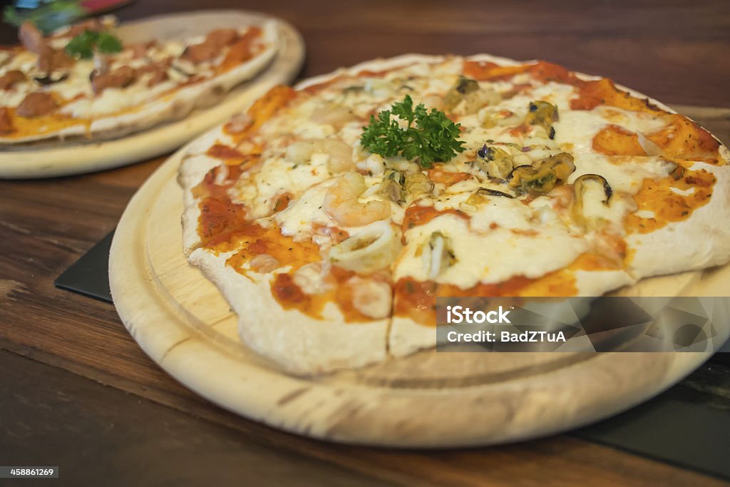 Seafood pizza produces from wood fired oven. Animal Shell Stock Photo