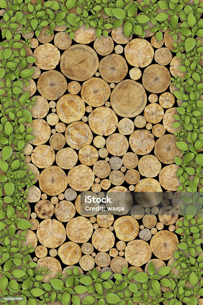 Stacked Logs Background Stacked Logs Background with green plant frame Backgrounds Stock Photo