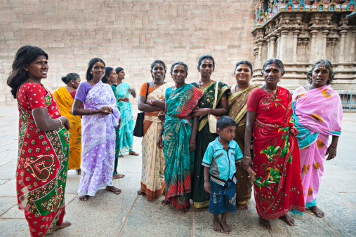 Madurai, India - March 22, 2012: Female pilgrims and unidentified child of 8-10 years near the Meenakshi Temple o