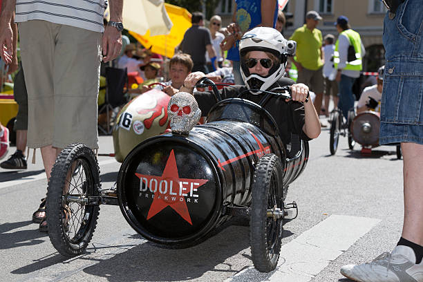 Munich, Germany - July 28, 2013: Each year there is a soapbox car race down the Gebsattelberg (small hill within Munich). Locals are competing for the funniest and fastest vehicles. On this image participants preparing for the start. A skull on one soapbox car.