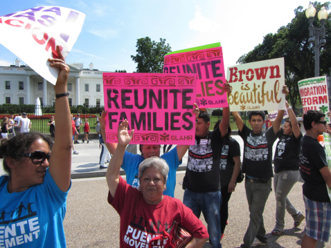 Washington DC, USA-July 24, 2013:  These protesters march in front of the White House in Washington DC to ask president Barack Obama to stop deporting latinos and reunite families.  Under his administration 1.7 million latinos have been deported-more than any other president.