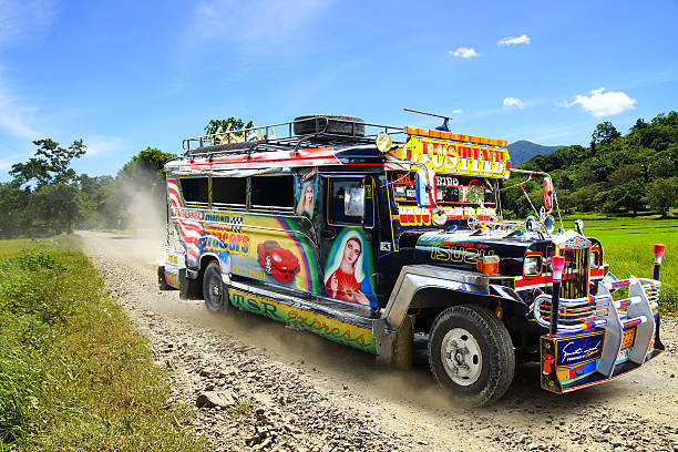 Jeepney on a rural road. Tagbilaran, Philippines - Febuary 10, 2013: Jeepney. Jeepneys are public transport. They were originally made from US military jeeps left over from World War II.  Tagbilaran in Philippines. bohol photos stock pictures, royalty-free photos & images