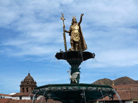 Cuzco, Peru - June 1, 2013: The statue of the Inca shining on top of the fountain in Cuzcoaas Plaza