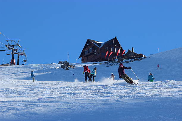 People skiing in front of Lynch Refuge - Andes Patagonia stock photo
