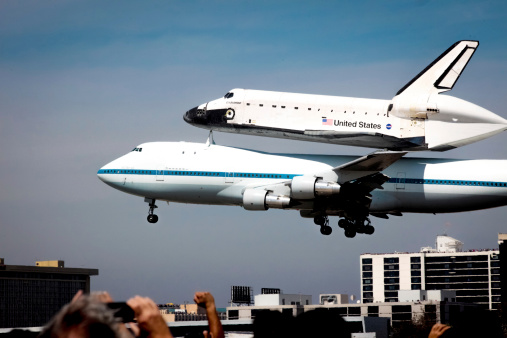 Los Angeles, California, USA - September 21, 2012: Space Shuttle Endeavor makes its final landing at noon at Los Angeles International Airport (LAX), marking an end to the space vehicle's aviation career. The shuttle is carried by a custom 747 designed by NASA to transport the shuttle from airport to airport.