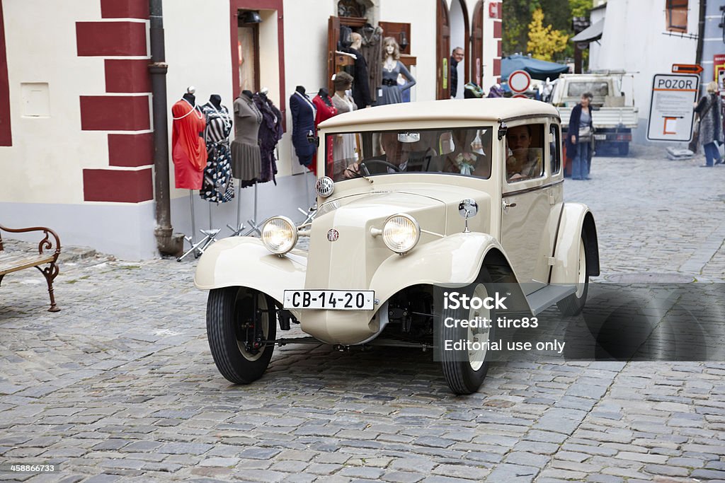 Vintage Tatra car used for Czech wedding Cesky Krumlov - September 29, 2012: Vintage Tatra car used for a Czech wedding on the medieval cobblestone streets of the picturesque Czech Republic town of Cesky Krumlov. The driver and bridesmaids are visible inside the car and perdestrians are pictured in the background. Bridesmaid Stock Photo