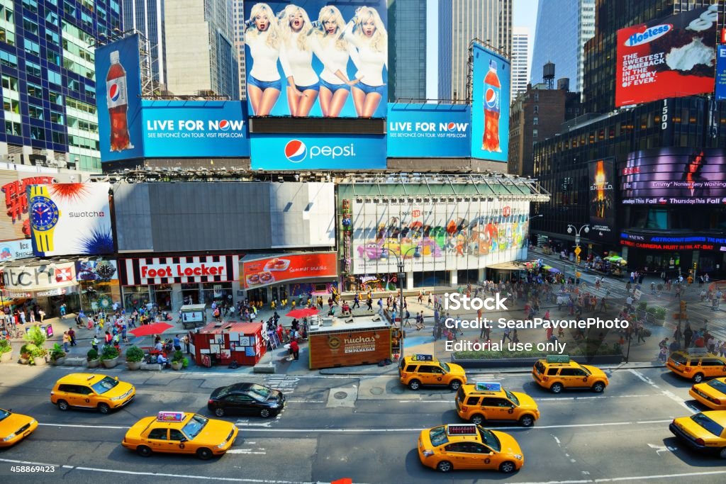 Times Square New York City, USA - August 21, 2013: Taxis pass through Times Square on Broadway. Times Square is one of the most visited attractions in the world with nearly 40 million people annually. Advertisement Stock Photo