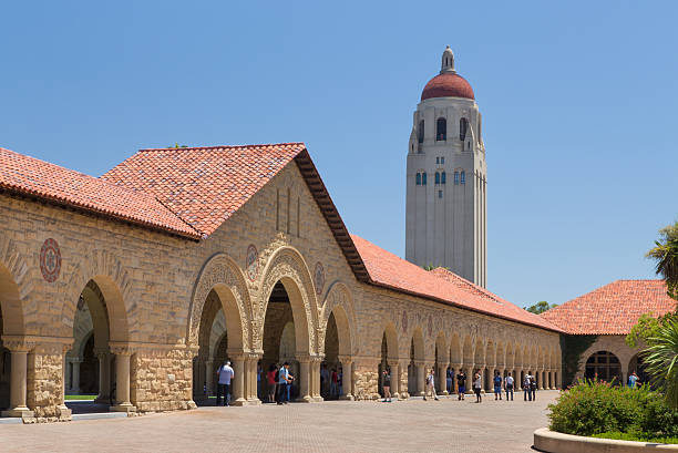 Stanford Courtyard Stanford, United States - July 6, 2013: Historic Stanford University features original sandstone walls with thick Romanesque features before a quadrant of open courtyards. stanford university photos stock pictures, royalty-free photos & images