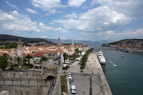 Famous travel and vacation destination. Amazing colorful sunrise, harbor with boats and luxury yachts. Medieval and historic old town, Trogir, Croatia, Europe