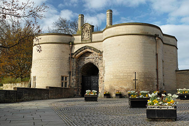 The gatehouse of Nottingham castle. Nottingham, United Kingdom - January 11, 2013: The gatehouse of Nottingham castle. The castle is a major Nottingham landmark and tourist attraction. The castle is built on a high piece of ground called castle rock. It dates back to 1067 when the first structure was built on the site by Norman the Conqueror. Since then the castle was re-built of stone and used by various kings throughout the ages. It was destroyed after the execution of Charles I, but restored by Charles II in 1660. The central Ducal Mansion that was built in the 1670's was burned down in a riot in 1832. This was later restored in 1875 and remains to this day a museum. nottingham stock pictures, royalty-free photos & images