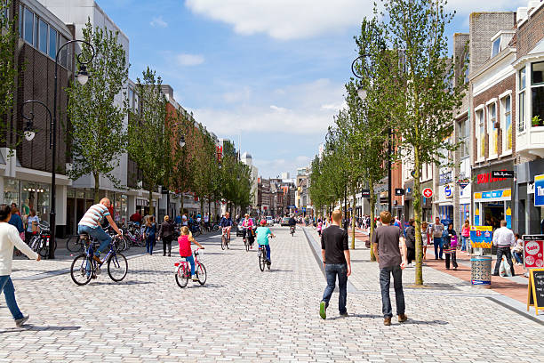 Busy shopping street in Dordrecht DORDRECHT, NETHERLANDS - JUNE 30, 2013: Busy shopping street with people walking and cycling in the sunny historic center of Dordrecht. The new shopping street was finished and opened in July of 2013. dordrecht photos stock pictures, royalty-free photos & images