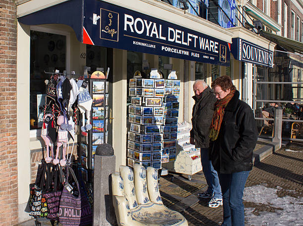 Tourists at Souvenirshop Delft, Holland - December 26, 2010: Tourists admire handicrafts at a souvenir shop in Delft, Holland on December 26, 2010 delft winter netherlands snow stock pictures, royalty-free photos & images