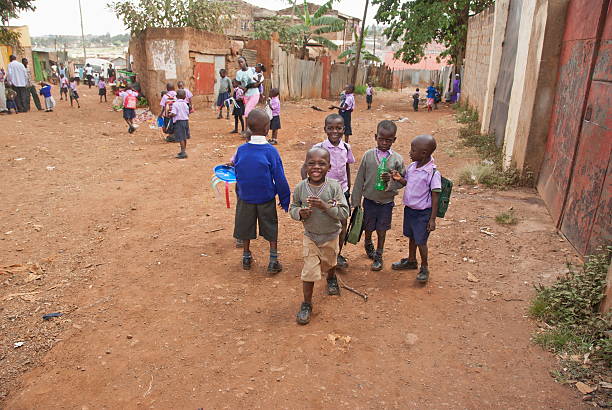 junge schule jungen auf einer straße von kibera, nairobi, kenia. - street child stock-fotos und bilder