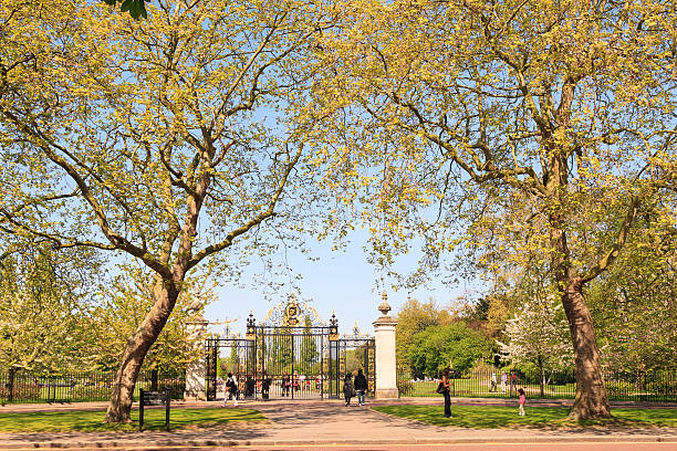 London, UK - April 24, 2009: Ornate gates at the South Entrance to Regents Park, London. The park is situated just North of the centre of London, containing a large lake, the residence of the  American Ambassador and London Zoo, as well as open playing fields and more formal gardens. It is a warm day in spring and visitors are seen attending the park.