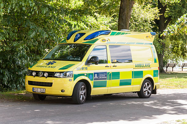 Swedish Ambulalance Stockholm, Sweden - July 17, 2013: A Swedish ambulance parked in the shadows of some trees beside one of Stockholms large parks, the RAYlambshovs park which in summertime is a wellknown place for outdoor activities such as sunbathing, picniques and partying and different sports. kungsholmen stock pictures, royalty-free photos & images